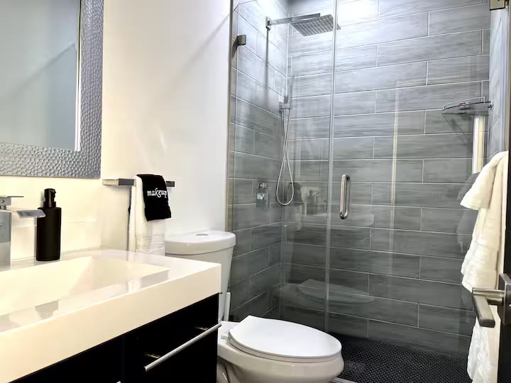Modern All-En-Suite Home - Bathroom Shower Modern All-En-Suite Home bathroom shower at a direct-booking vacation rental in Phoenix, Arizona