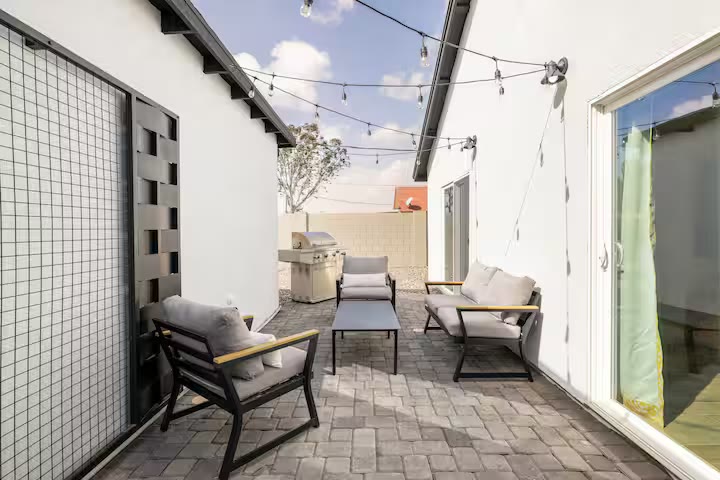 Modern All-En-Suite Home - Patio Seating Modern All-En-Suite Home patio seating at a direct-booking vacation rental in Phoenix, Arizona