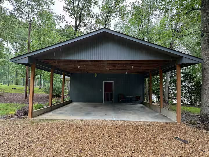 The Angler's Canoe Lake House - Cabin Exterior Side View The Angler's Canoe Lake House cabin exterior side view at a direct-booking vacation rental in Cedar Bluff, Alabama